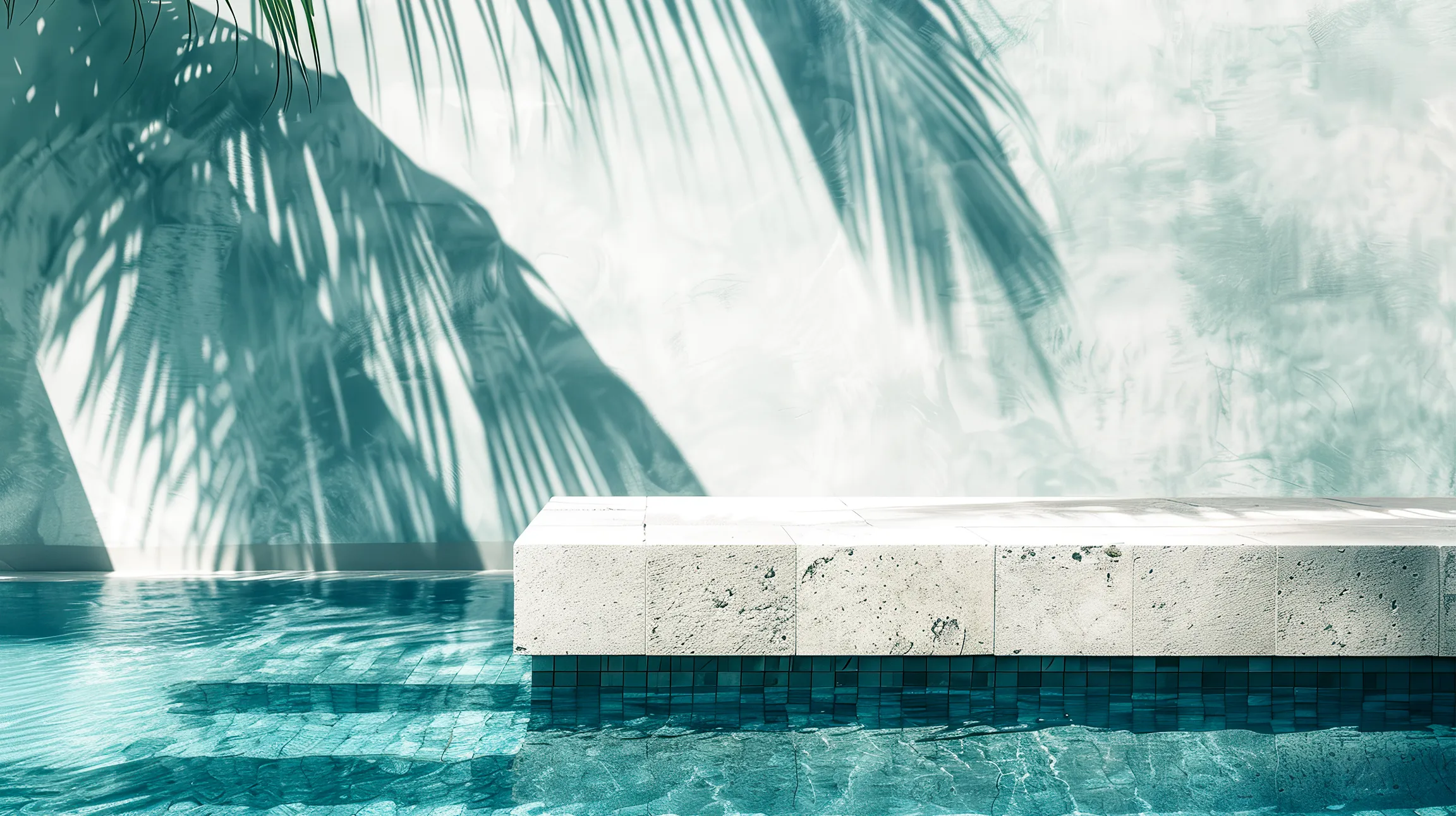 Palm shadows falling across the stone edge of a hotel pool.